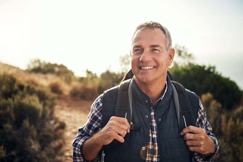 smiling man hiking with backpack