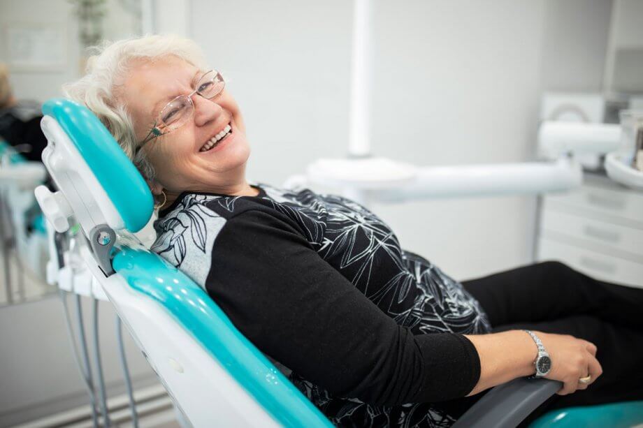 smiling older woman in dental exam chair